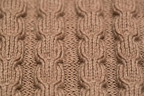 knitted fabric background texture gold. Knitted ornament.