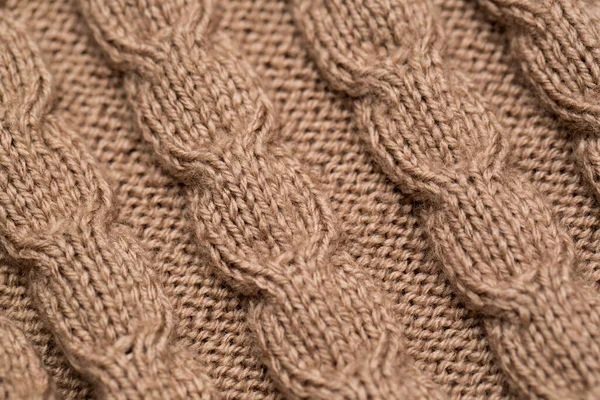 Knitted fabric background texture gold. Knitted ornament. — Stock Photo, Image