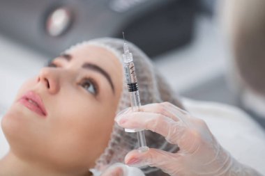 Şırınga ile yüz hatları ya da büyütme için dolgu. Model, bakış açısı. Kozmetik kliniği. Sağlık, kozmetoloji, klinik.