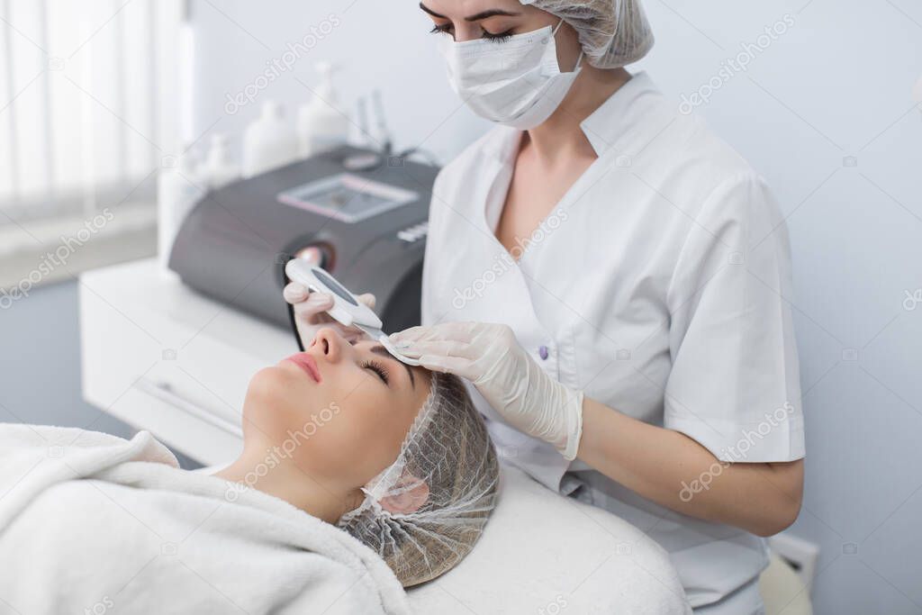 Skin Care. Close-up Of Beautiful Woman Receiving Ultrasound Cavitation Facial Peeling. Ultrasonic Skin Cleansing Procedure. Beauty Treatment. Cosmetology. Beauty Spa Salon