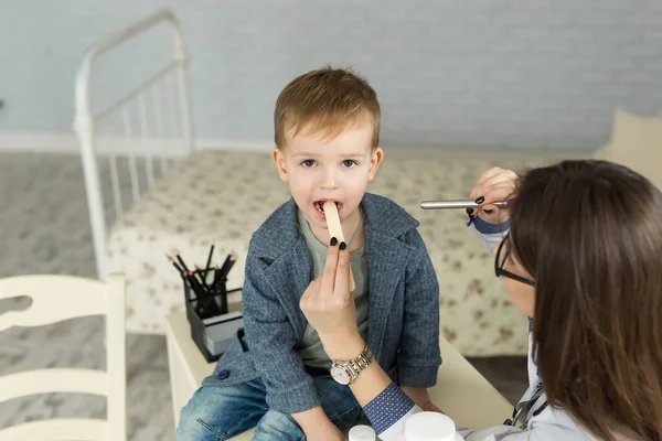 Ärzte untersuchen die Kehle der Kinder. Junge in Kinderarztpraxis — Stockfoto