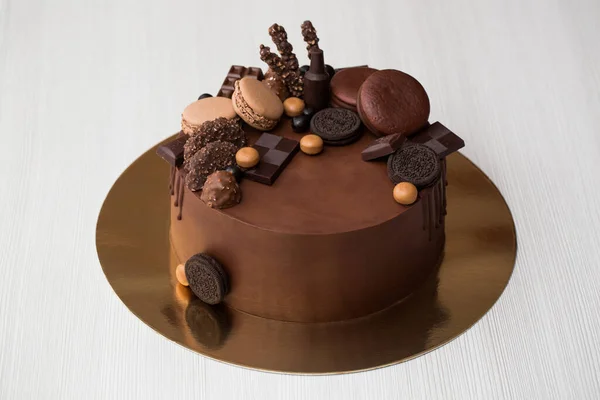 Chocolate cake for men with chocolate decorations and the streaks of chocolate.