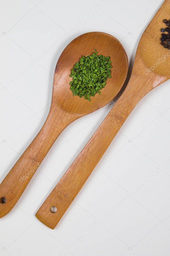 Wooden ladles with some herbs and food spices