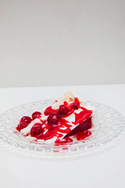 Piece of cherry cake on a glass plate