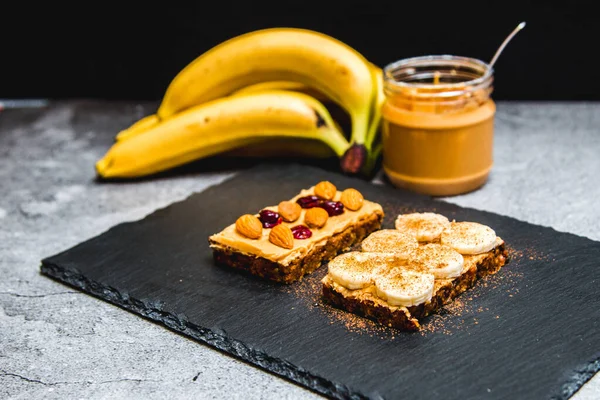 Healthy breakfast with fitness bread, peanut butter, nuts and bananas