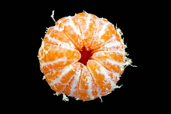 Peeled one tangerine on a black background — Stock Photo, Image