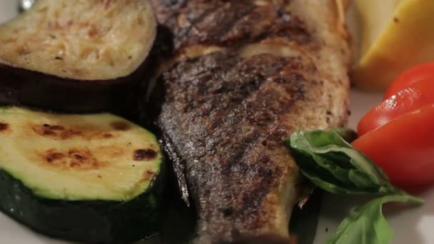 Macro Fish Tail Decorated with Vegetables Rounds on Plate — Stock Video