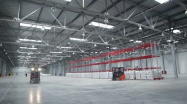 Kargo makinesi kocaman, geniş, geniş ve büyük kutuları olan bir depoda hareket eder.