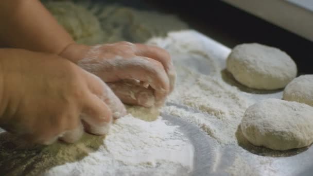 Hands kneading dough on board with flour — Stock Video