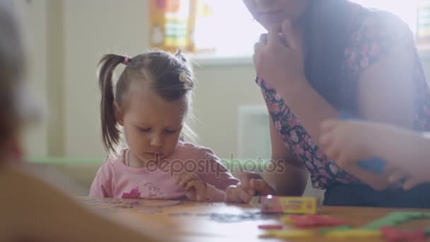 Nursery-guess showing details to girl — стоковое видео