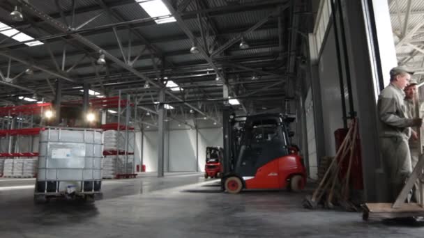 Forklift driving out from plant workshop — Stock Video