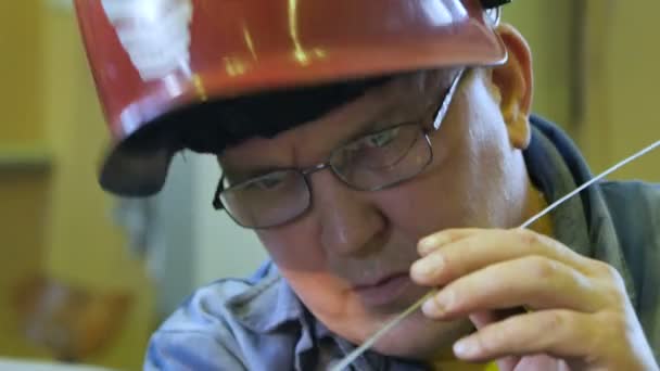 俄罗斯 2016年6月12日 关闭红色头盔焊缝特写车间工作人员在6月12日在喀山的工厂用长金属工具施工 — 图库视频影像