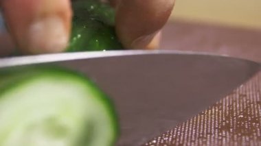 restoranda mutfak tahtada metal bıçak ile ustaca taze salatalık makro profesyonel aşçı keser