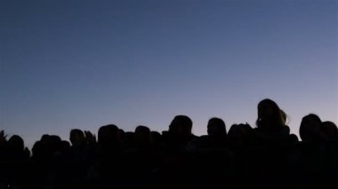 Kazan, Tataristan/Rusya - 03 Kasım 2017: Çit arkasındaki insanlar siluetleri üzerinde 03 Kasım kazan ünlü şarkı sayısı eğlence merkezi mavi akşam gökyüzü karşı kare üzerinde alkışlıyorum