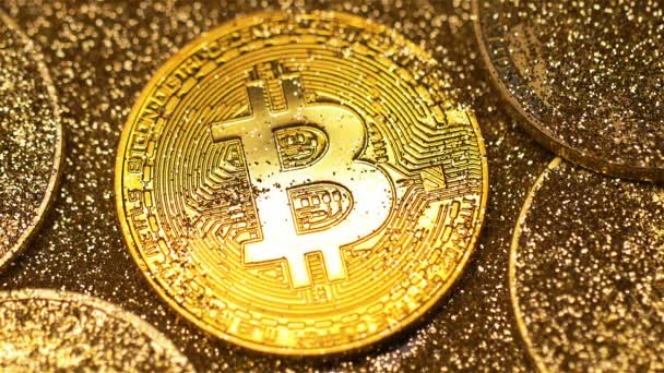 マクロ高級黄金 Bitcoin 実寸モデルのコインの中で光線で明るく光るし 影で覆われて — ストック動画