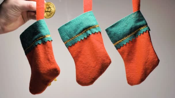 Closeup Man Hand Puts Gold Bitcoin Models Red Green Christmas — Stock Video