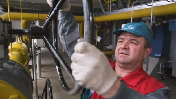 Le travailleur tourne la vanne montée sur le tuyau pour le pompage d'huile — Video