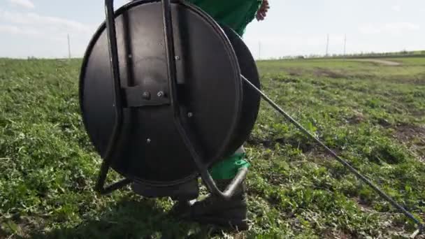 Facharbeiter Grüner Uniform Schleppt Große Schwarze Spule Mit Kabel Über — Stockvideo