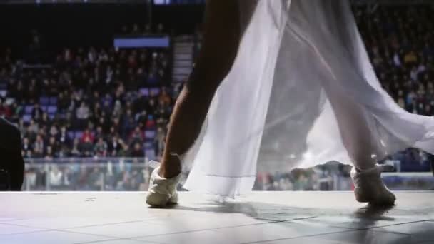 Woman in chiffon skirt dances near ice arena slow motion — Stock Video