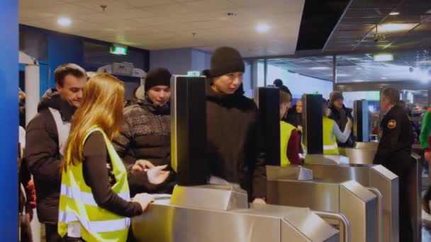 Människor passerar turnstile för att kontrollera biljetter kommer till stadion — Stockvideo