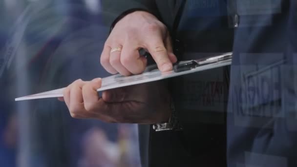 Trainer with clipboard checks game plan closeup slow motion — Stock Video