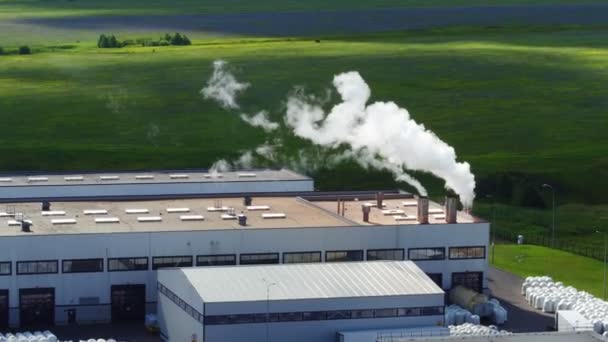 Chimneys with steam on production plant workshop upper view — Stock Video