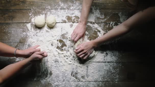 Пекари месить тесто на деревянном столе замедленного движения верхний вид — стоковое видео