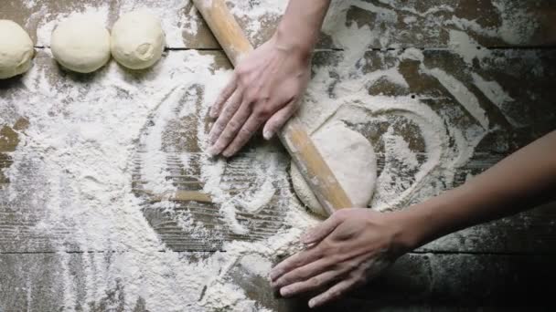 Girl rolls dough with pin on old table closeup slow motion — 图库视频影像