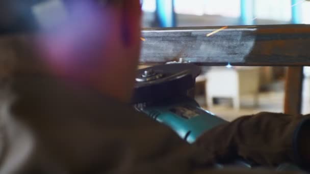 Man grinds connected by welding metal carcass closeup — Stock video