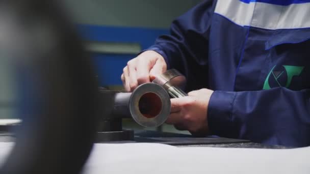 Worker assembles control skid detail at workplace closeup — Stock Video