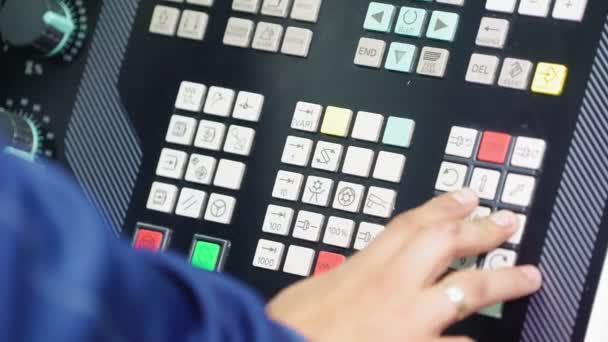 Engineer works with control panel of machine tool in shop — 图库视频影像