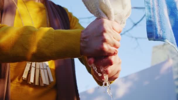 Femme en vêtements jaunes torchons serviette suspendue sur corde gros plan — Video