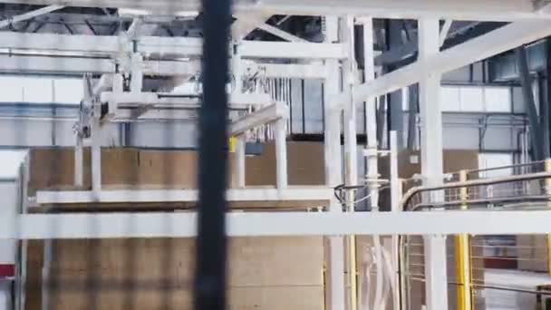 Machine puts stone wool insulation onto conveyor in workshop — Stock Video