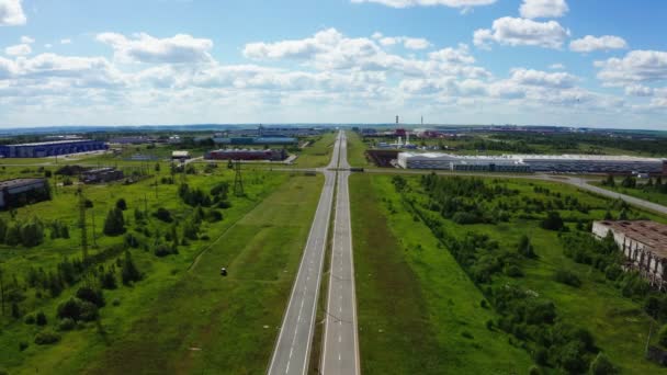 Road with round junction near industrial complex aerial view — 비디오