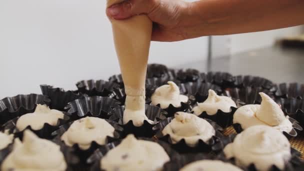 Pouring dough with raisins into forms in bakery workshop — ストック動画