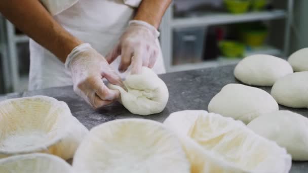 Chef kneads fresh dough piece at table in bakery workshop — Stock Video