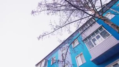 motion along blue repaired dwelling building on winter day