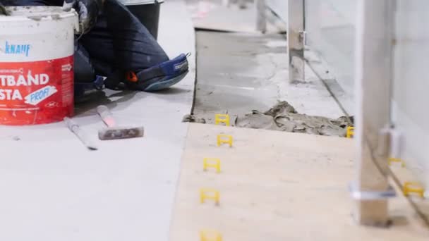 Builder puts concrete mix onto floor with spatula closeup — Stock Video