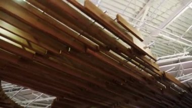 stylish wooden decoration with boards hangs under ceiling
