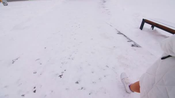 Schoolgirls in warm jackets with backpacks walk to school — Stock video