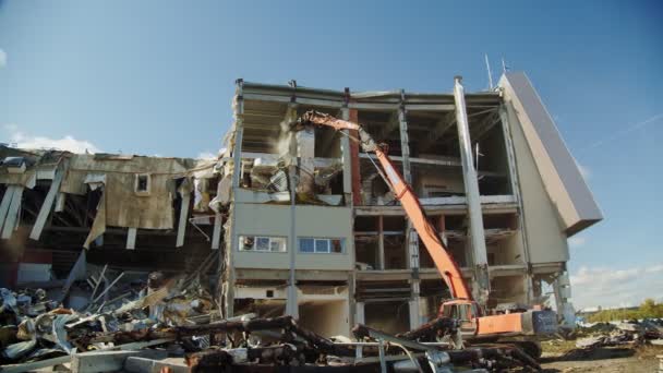 Machine vernietigt oude verlaten hockey stadion tegen de hemel — Stockvideo