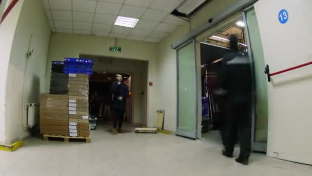 Workers carry boxes with goods in supermarket warehouse — Stock Video