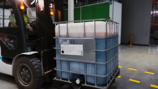 Forklift loader carries container with chemicals to cabinet — Stock Video