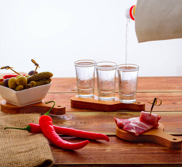 Shots of vodka on a wooden table