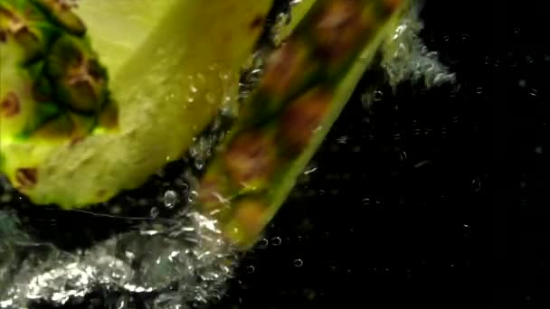 Сочный ананас упал в воду. — стоковое видео