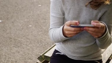 Kız arkadaşımla, smartphone üzerinde oynarken parkta mutlu kız konuşmak 