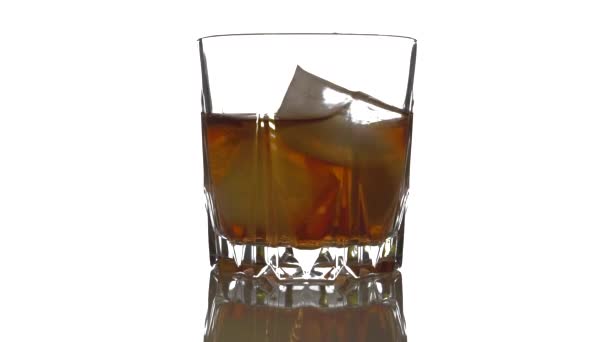 Close Ice Cubes Rotating Melts Glass Whiskey Isolated White Background — Stock Video