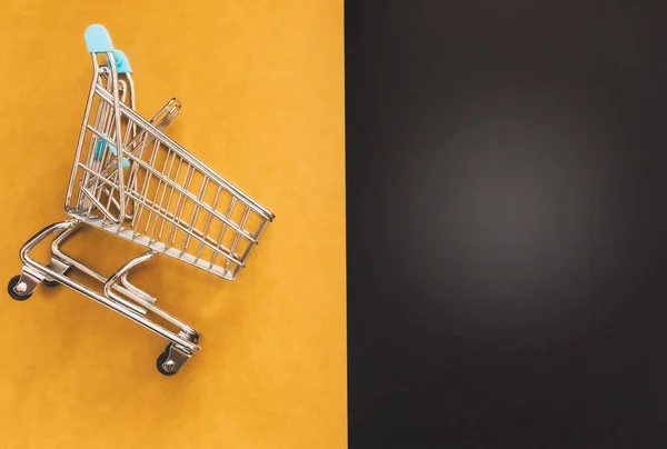 Close Blue Shopping Trolley Yellow Black Background Some Copy Space — Stock Photo, Image