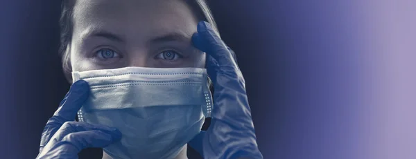 Caucasian Girl wearing protection face mask and blue nitrile surgical gloves against coronavirus. Banner panorama medical staff preventive gear