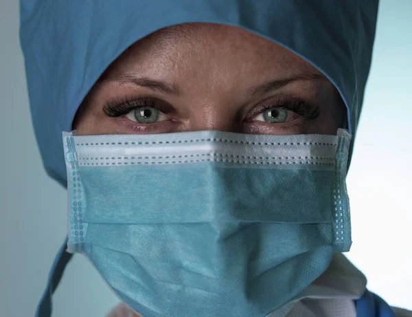 Tired doctor in mask looks at camera. Close up. Selective focus